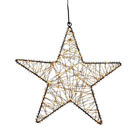 Julestjerne til vindu. Elegant julebelysning ute